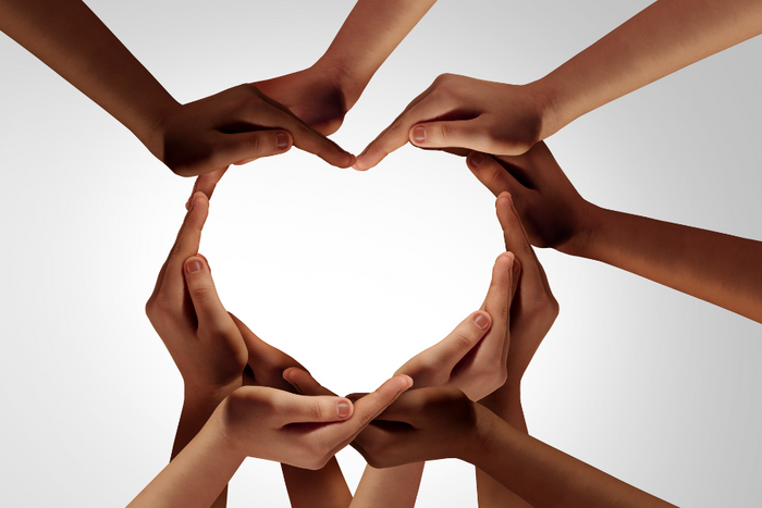 Diverse hands forming a heart shape in the center, symbolizing community care, inclusion, and support.